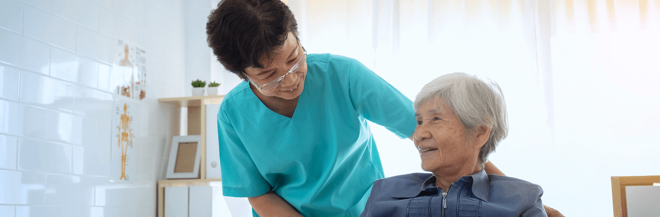 caregiver helping elderly woman