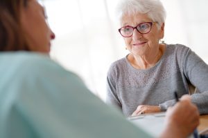 Dayspring Villa Assisted Living Community in Denver, CO - senior woman with adult child working on finances Dayspring Villa Assisted Living Community in Denver, CO - senior woman with adult child working on finances
