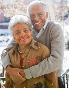 senior couple smiling outside