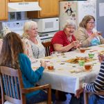 Older adults talking and sharing a meal