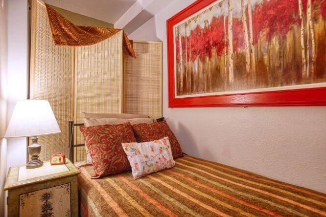 Dayspring Villa Assisted Living Community in Denver, CO - twin bed red bedroom landscape