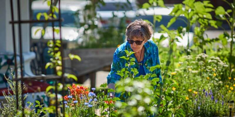 Dayspring Villa Assisted Living Community in Denver, CO - woman in garden sub nav menu