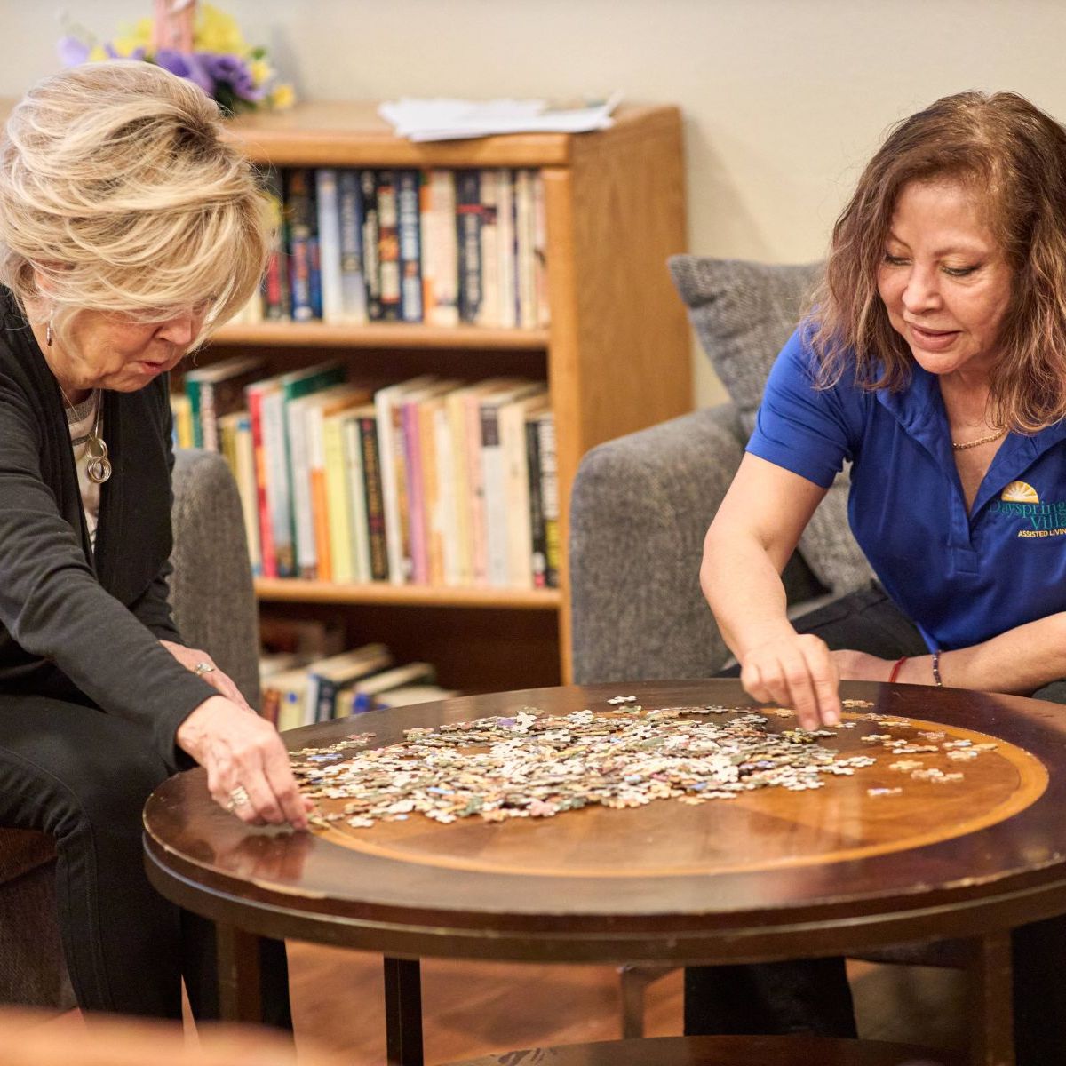 Dayspring Villa Assisted Living Community in Denver, CO - staff and resident solving jigsaw puzzle