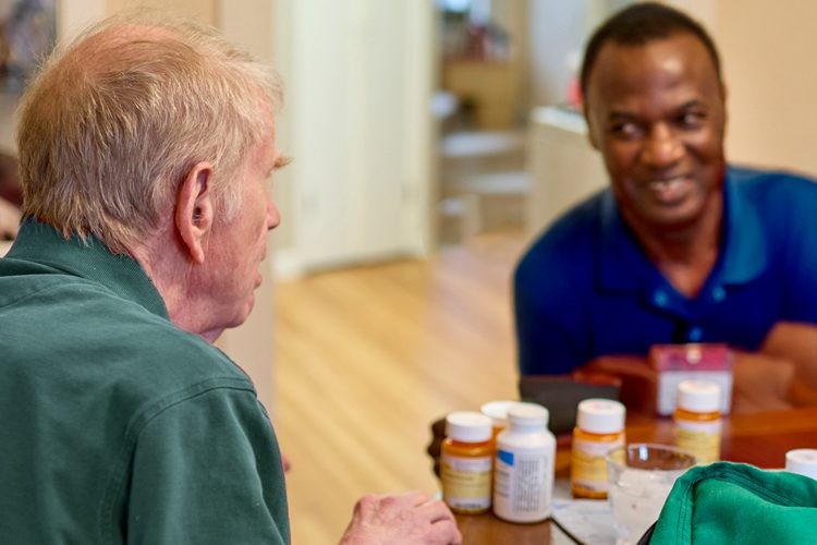 Dayspring Villa Assisted Living Community in Denver, CO - dsv caregiver helping senior man with medication Dayspring Villa Assisted Living Community in Denver, CO - dsv caregiver helping senior man with medication