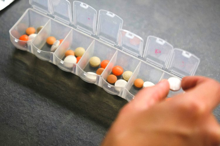 Dayspring Villa Assisted Living Community in Denver, CO - dsv hand putting meds in pill box Dayspring Villa Assisted Living Community in Denver, CO - dsv hand putting meds in pill box