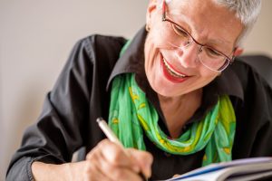 Dayspring Villa Assisted Living Community in Denver, CO - senior woman writing in a journal