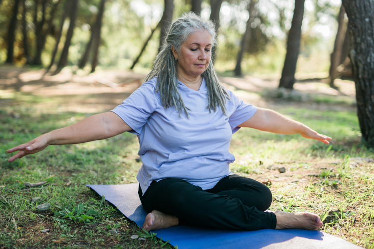 Dayspring Villa Assisted Living Community in Denver, CO - dayspring villa senior woman doing yoga on mat
